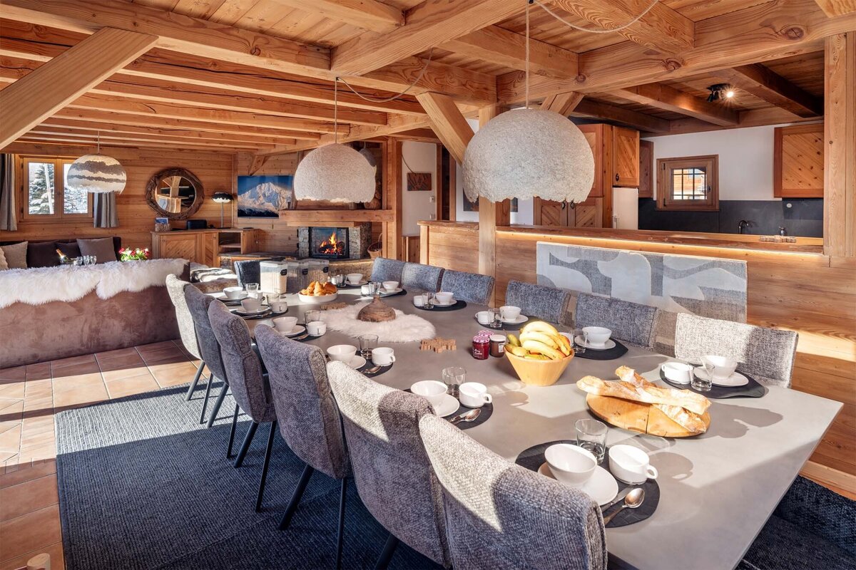 A dining room table with a bowl of bananas on it