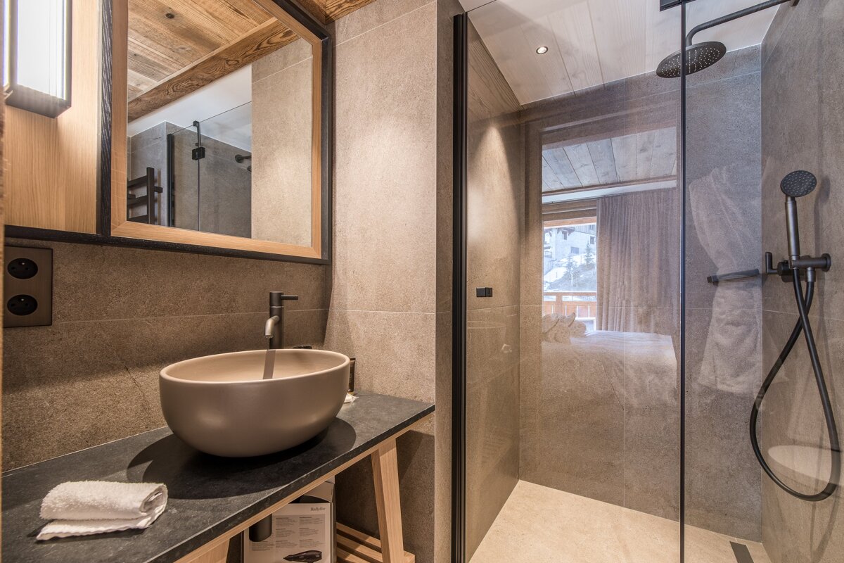 A bathroom with a sink and a walk in shower