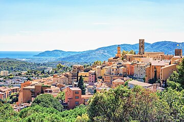 An aerial view of a small town with mountains in the background