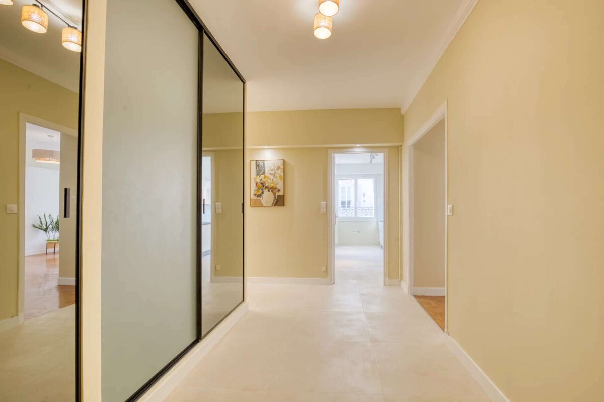 A hallway with a picture of flowers on the wall