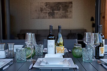 A bottle of rare vineyards wine sits on a table