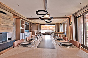 A dining room table with plates and glasses on it