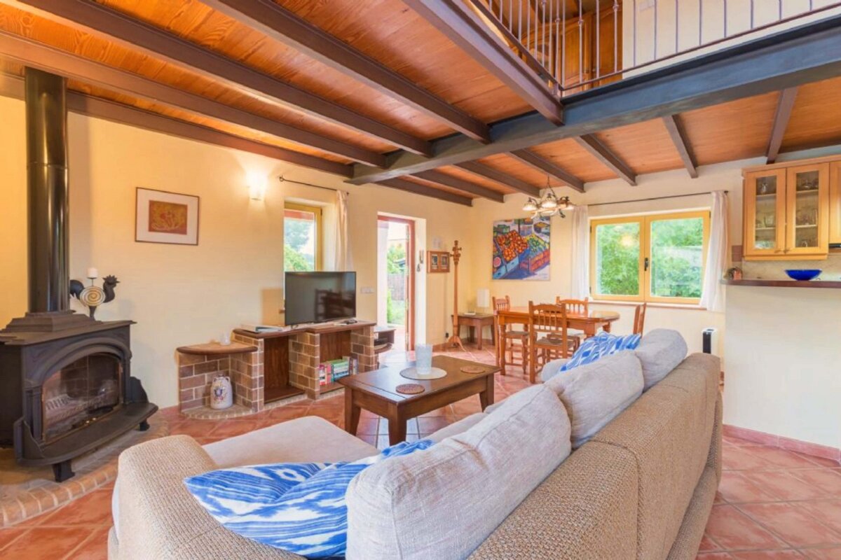 A living room with a fireplace and a flat screen tv
