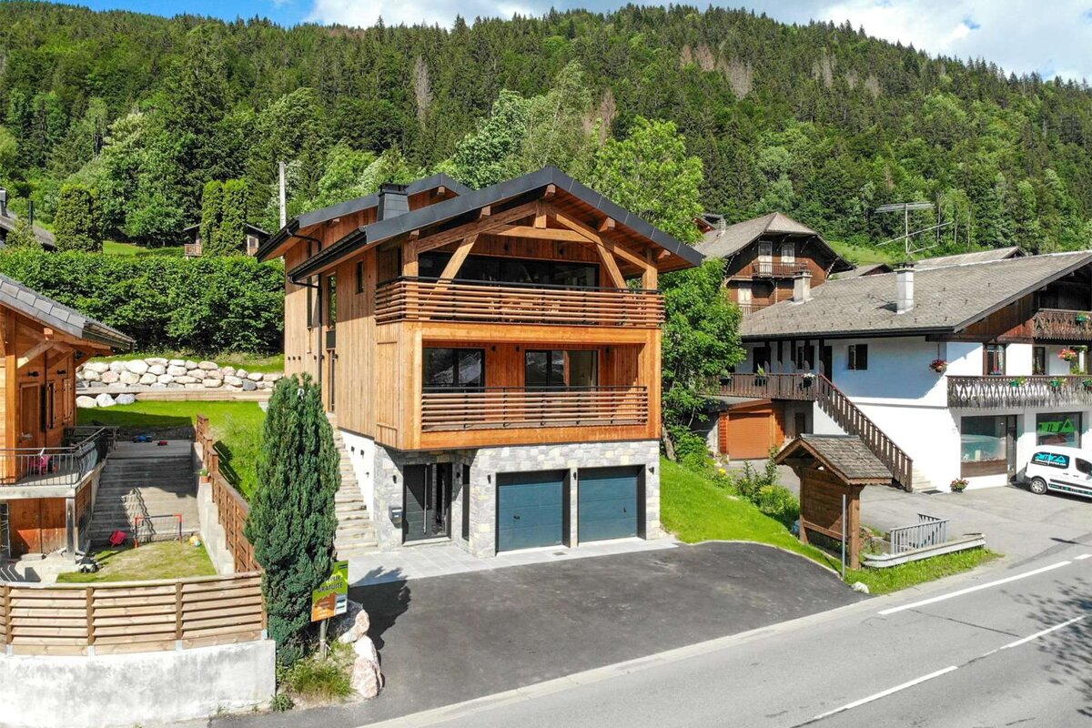 A white van is parked in front of a large house