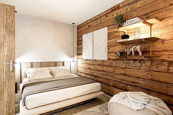A cozy, modern bedroom featuring a prominent rustic wood plank accent wall, a neutral-toned bed, and stylish decorative shelves.