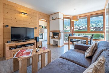 A living room with a couch and a flat screen tv