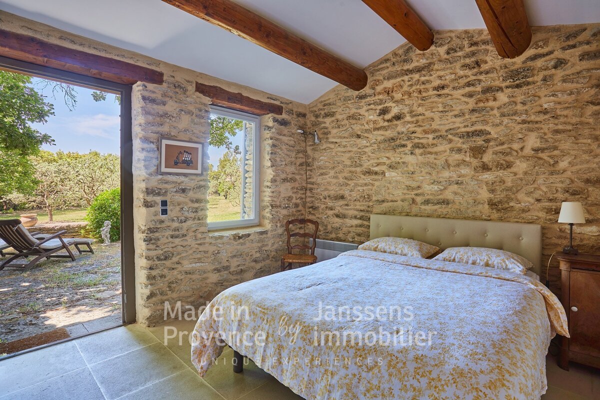 A bedroom with a bed and a picture on the wall that says made in provence by immobilier
