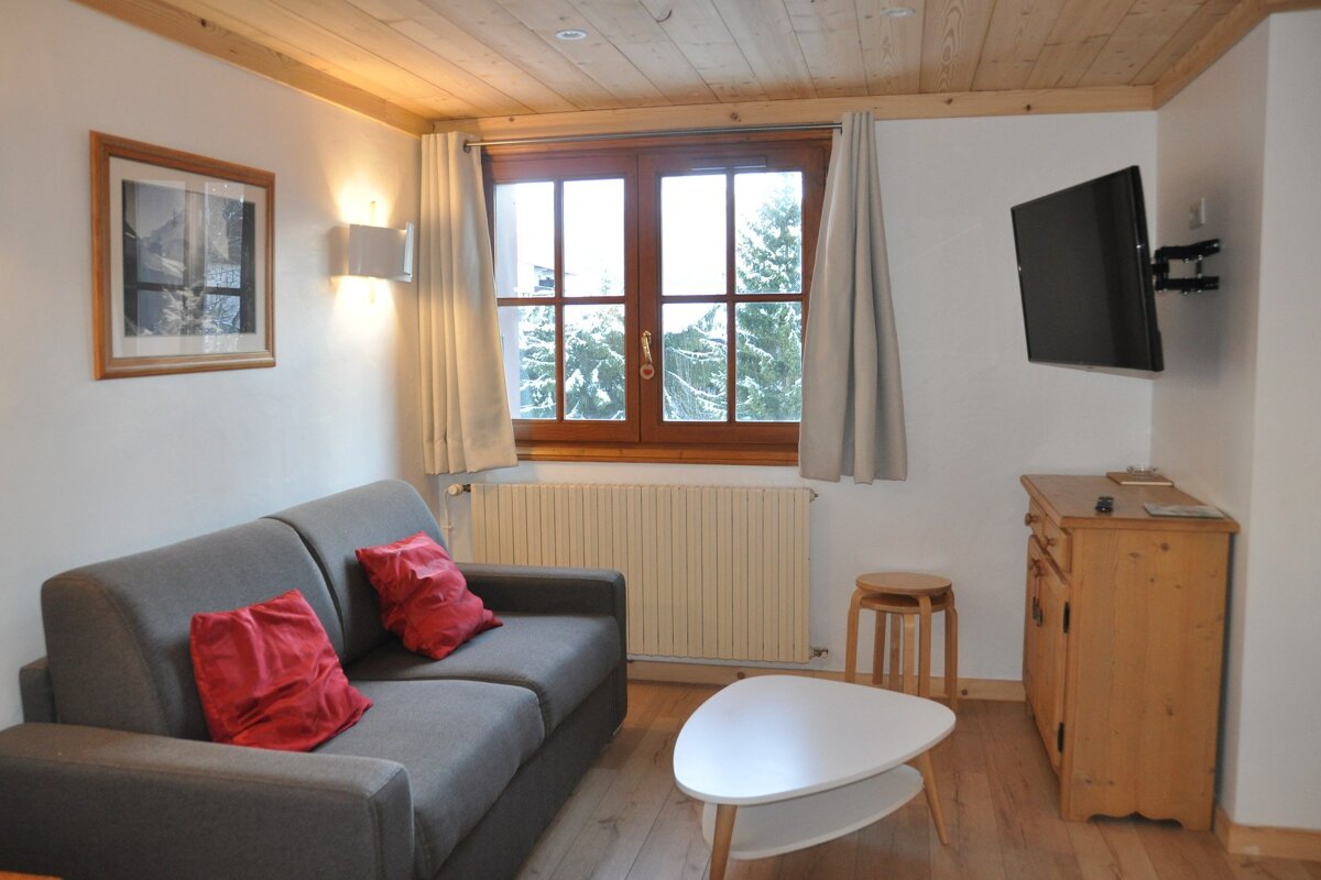 A living room with a couch and a flat screen tv