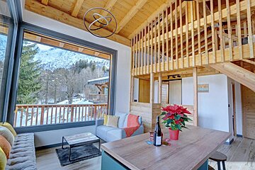 A bottle of wine sits on a table in a living room