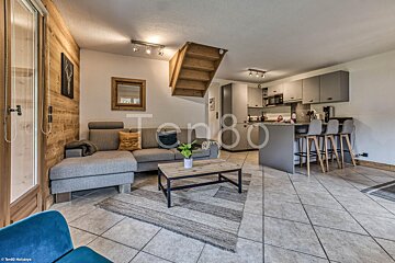 A living room with a couch and a coffee table with the number 80 on it