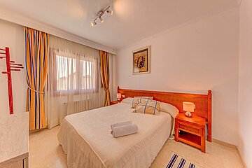 A bedroom with a large bed and two nightstands