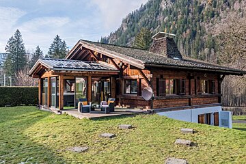 A wooden house with a satellite dish on the roof