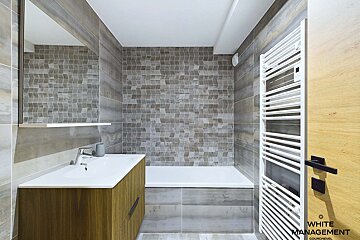 A bathroom with white management written on the door