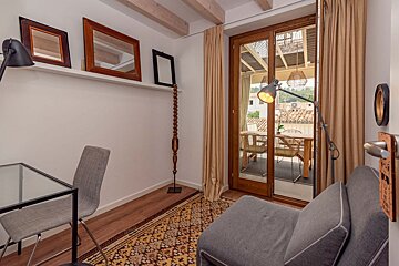 A room with a chair a table and a lamp