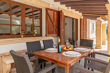 A table with plates and a bottle of wine on it