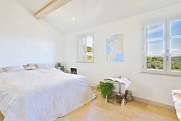 A bedroom with a map of france on the wall