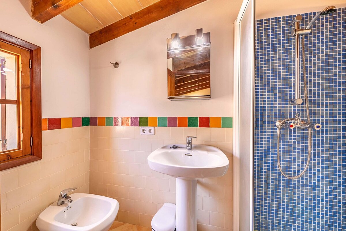 A bathroom with a sink a toilet and a shower