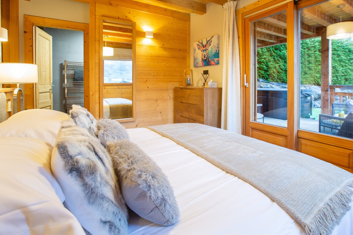 A bedroom with a large bed and sliding glass doors