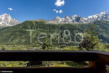 A view of mountains from a balcony with the words ten80 holidays visible