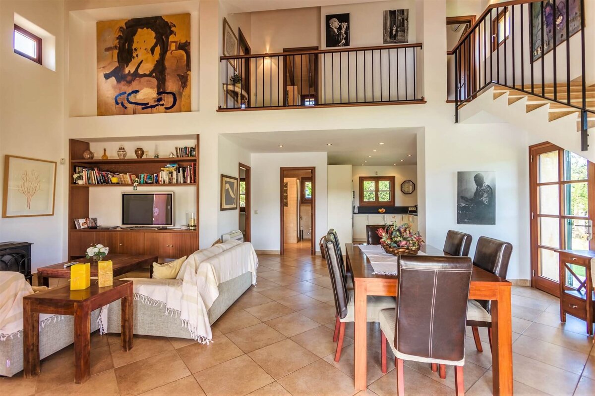 A living room with a couch a table and a television