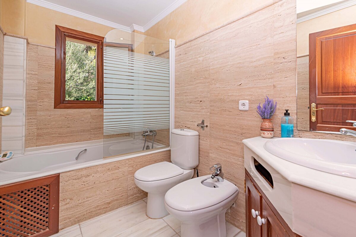 A bathroom with a sink toilet and bathtub