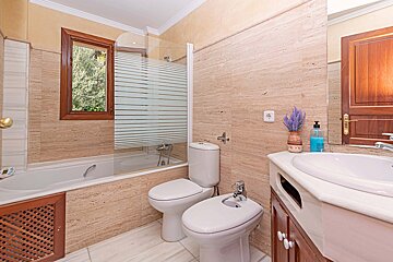 A bathroom with a sink toilet and bathtub