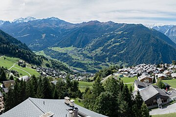 A view of a valley with mountains in the background