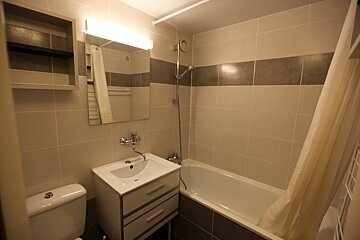 A bathroom with a sink a toilet and a bathtub