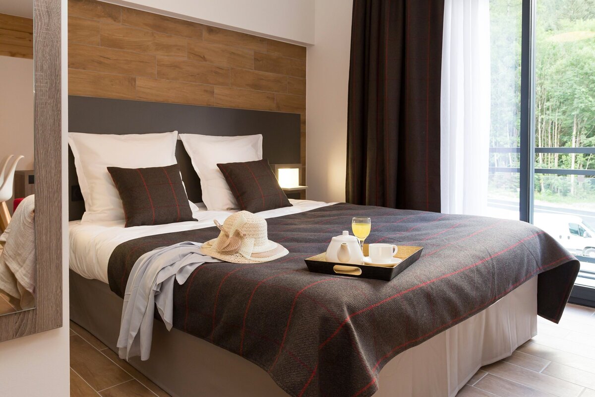 A hotel room with a bed and a tray on it