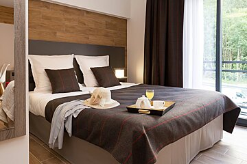 A hotel room with a bed and a tray on it