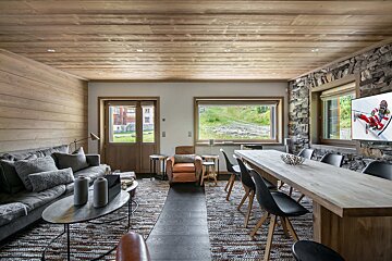 A living room with a large table and chairs