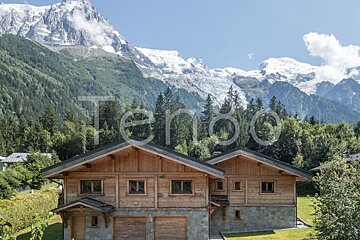 A photo of a chalet with mountains in the background taken by tenoo holidays