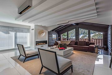 A living room with a couch and chairs and a fireplace