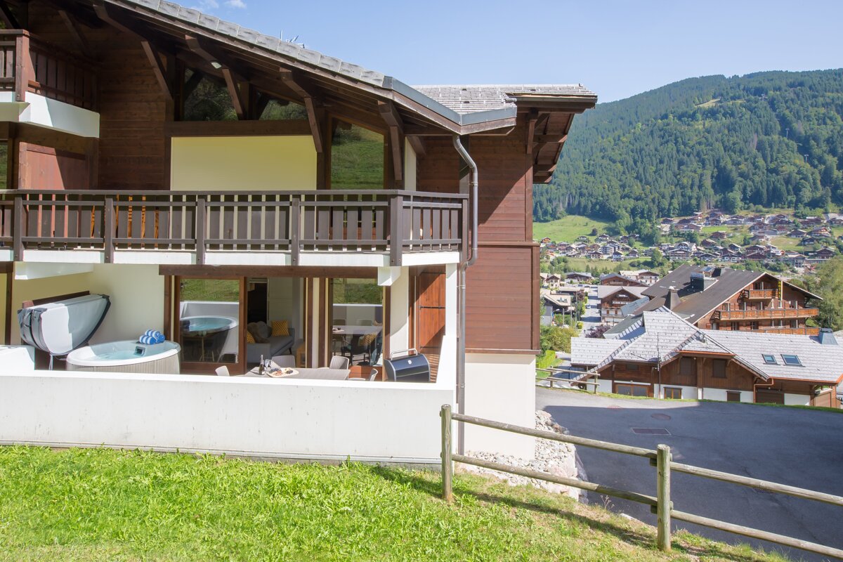 A house with a balcony overlooking a small town