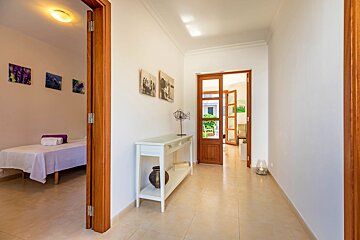 A hallway with a table and a vase on it