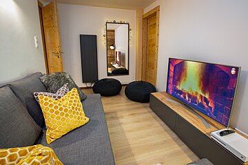 A living room with a couch and a flat screen tv