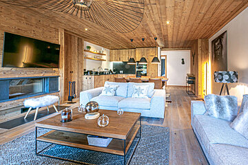 A dining room with a table and chairs and a cowhide rug