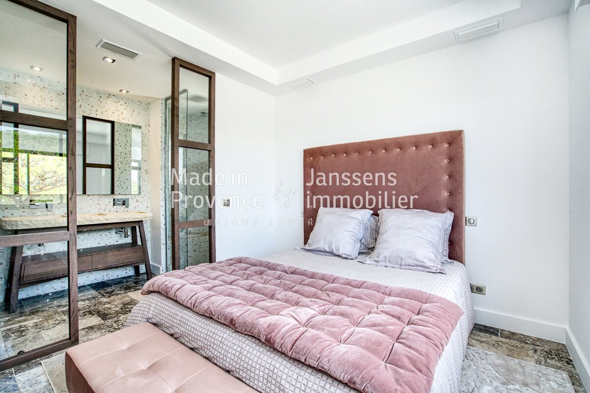 A bedroom with a bed and a sign that says janssens immobilier