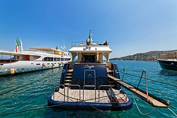 A boat with the name brugia on the back of it