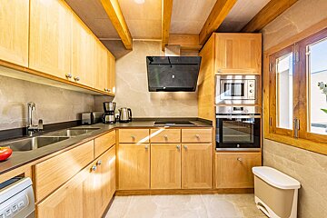 A kitchen with stainless steel appliances and wooden cabinets