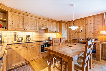 A kitchen with wooden cabinets and a table with vip written on it