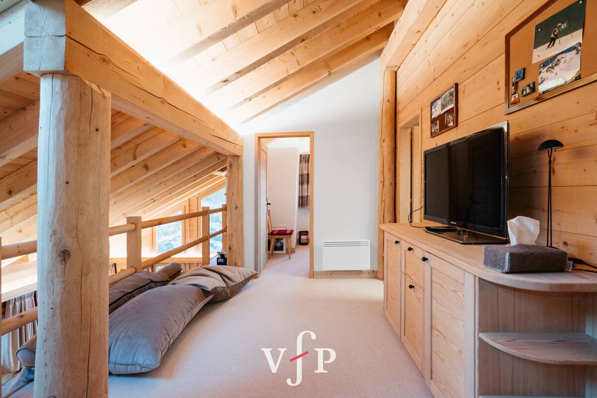 A wooden hallway with a tv and a sign that says vjp
