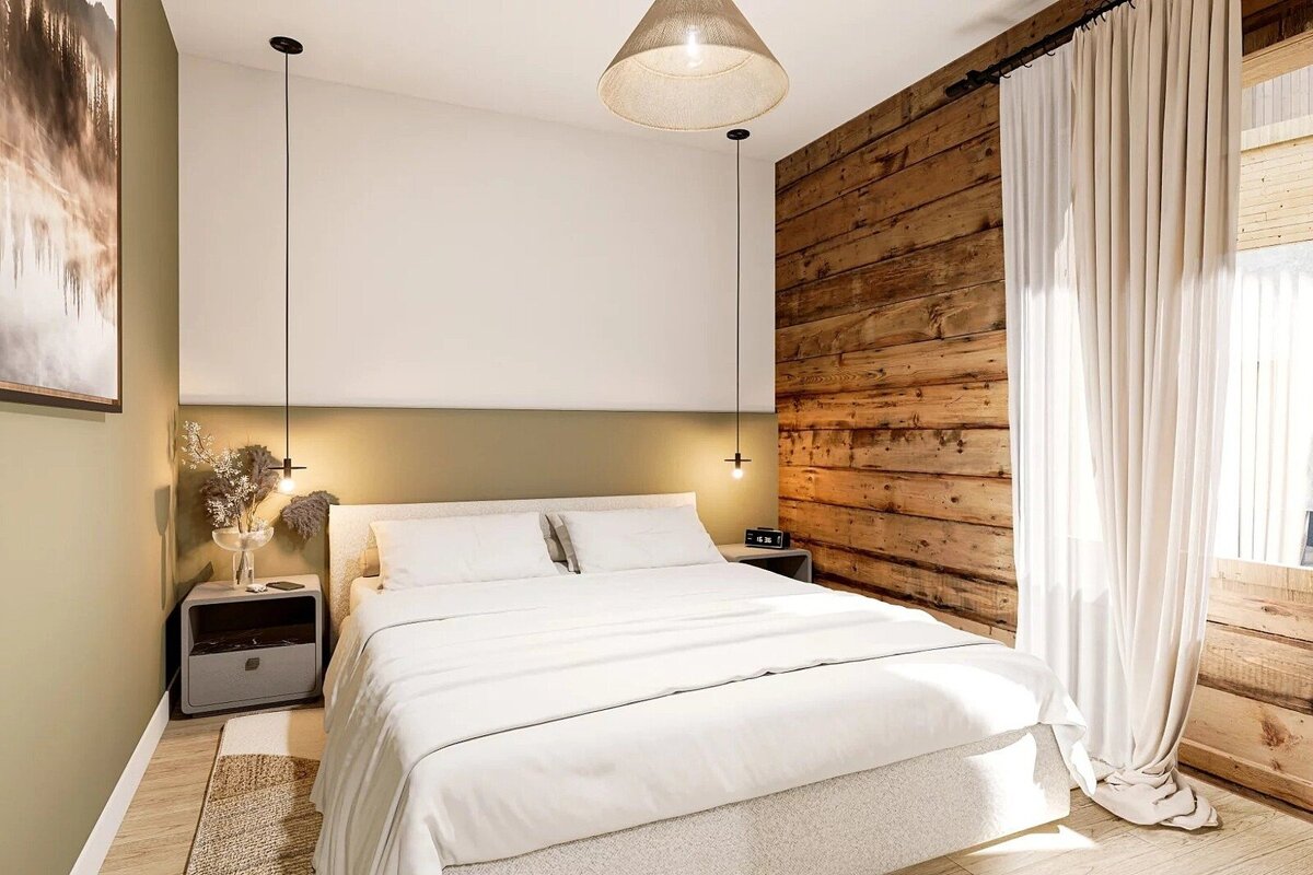 A cozy, modern bedroom with a white bed, a prominent wooden accent wall, and olive green headboard. Minimalist pendant lights and light curtains add to the serene ambiance.