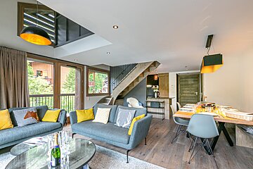 A bottle of champagne sits on a table in a living room