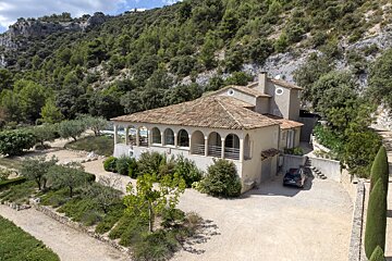 A large house with a car parked in front of it