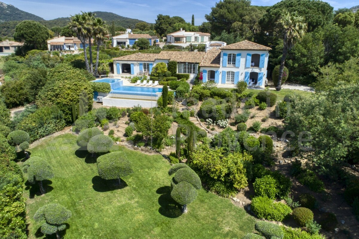 An aerial view of a large house with a swimming pool