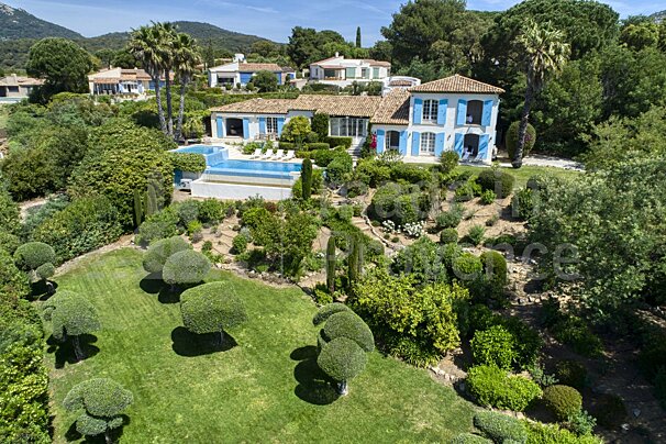 An aerial view of a large house with a swimming pool