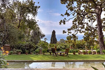 A view of the ocean from a lush green garden