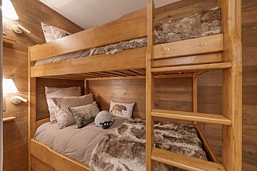 A bunk bed with a stuffed animal on it