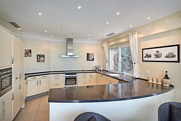 A kitchen with a bottle of wine on the counter
